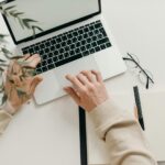 pexels-cottonbro-4065876-scaledjpg - IT Done Right LLC Free An overhead view of a person working on a laptop in a minimalist home office setting. Stock Photo