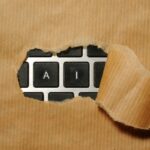 AI-for-Efficiency_-How-to-Automate-Daily-Tasks-and-Free-Up-Your-Time-Without-a-Huge-Budget-scaledjpg - IT Done Right LLC A piece of cardboard with a keyboard appearing through it
